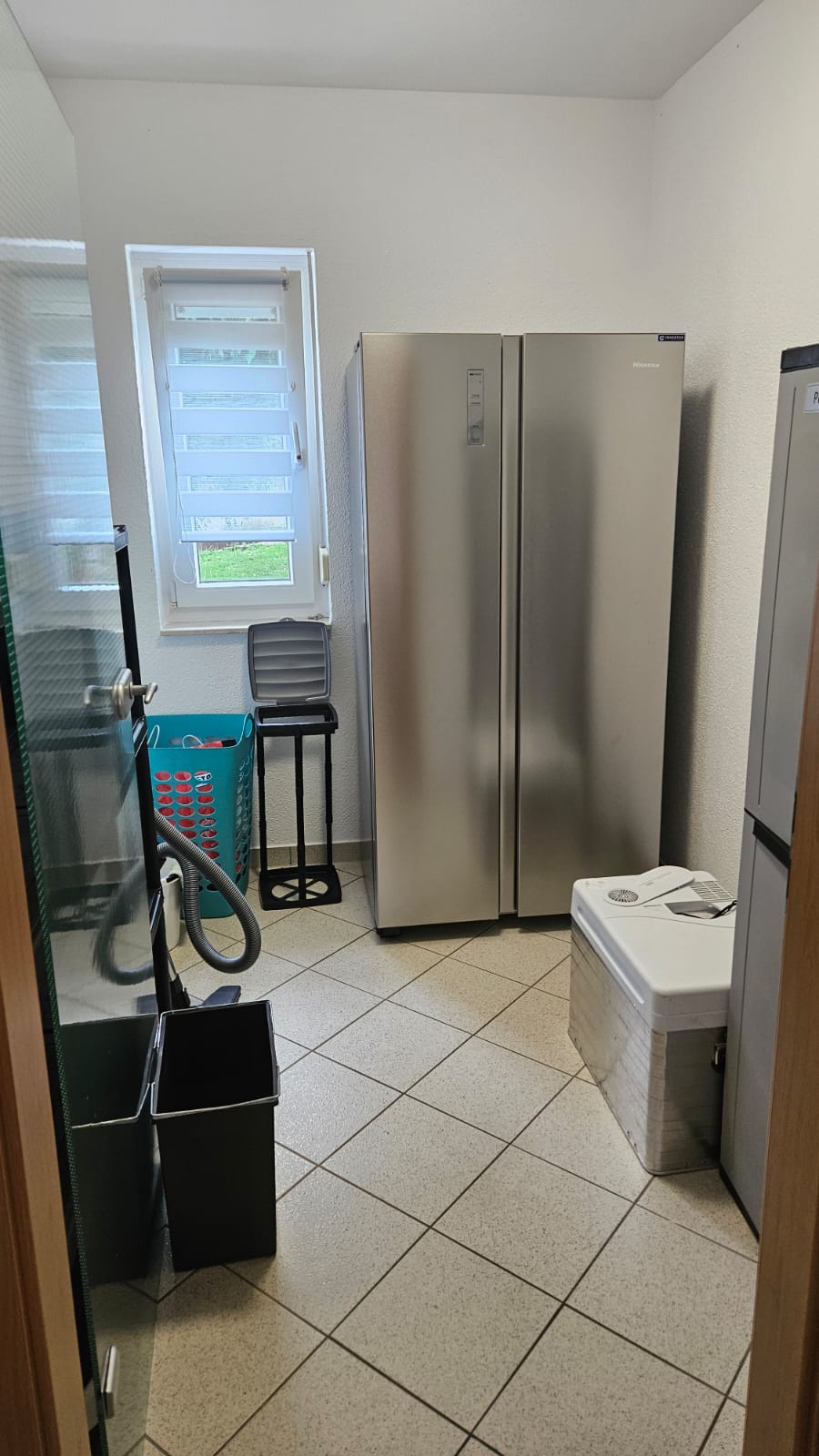 Abstellkammer mit Kühlschrank Küche mit Kühlschrank, Kühltruhe, Stauraum und Reinigungsausrüstung.